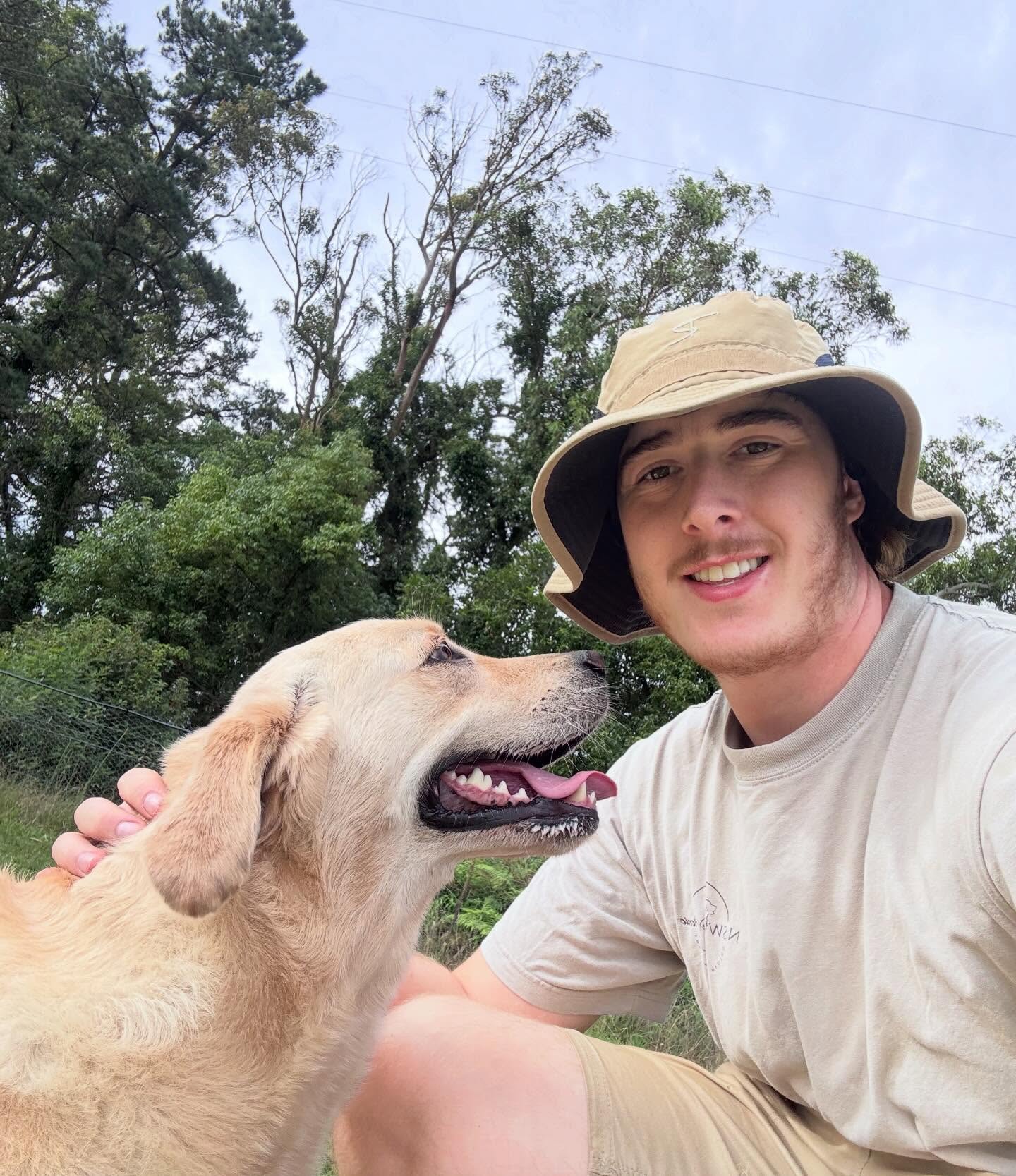 Quinn outdoors with a labrador
